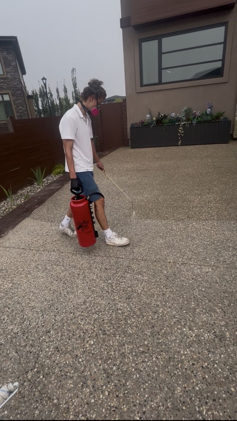 Applying sealer to a residential driveway