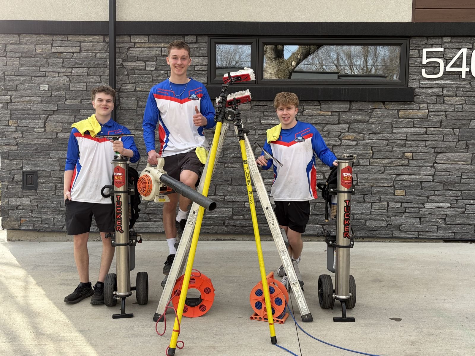 The Wash & Shine Co. crew with their window cleaning and pressure washing equipment