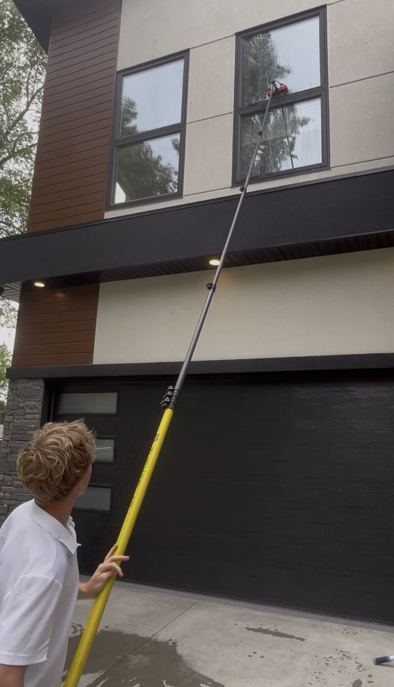 Water-fed pole reaching a second-story window in Edmonton